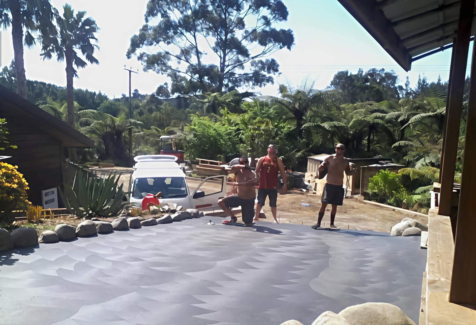 Custom dragon scale trowel finish on a freshly placed concrete driveway by Henwood Concrete.